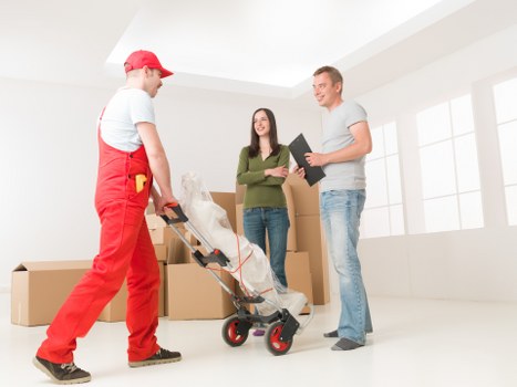 Professional movers handling office equipment
